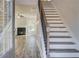 Inviting entryway with staircase and view into the living room with fireplace at 161 Haverling Pass, Hampton, GA 30228