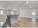 Bright hallway features wood floors, decorative lighting and decorative railing at 161 Haverling Pass, Hampton, GA 30228