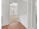 Bathroom showing tub and shower combo, wood floors, and bedroom doorway at 1795 Waterside Nw Dr, Kennesaw, GA 30152