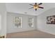 Spacious bedroom with natural light, ceiling fan, and neutral carpet at 1795 Waterside Nw Dr, Kennesaw, GA 30152