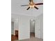 Bedroom with ceiling fan, neutral carpet, and white walls connecting to bathroom at 1795 Waterside Nw Dr, Kennesaw, GA 30152