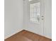 Well-lit entryway with wood-look flooring and a white door with blinds at 1795 Waterside Nw Dr, Kennesaw, GA 30152
