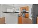 Open kitchen with breakfast bar, stainless steel appliances, and modern lighting at 1795 Waterside Nw Dr, Kennesaw, GA 30152