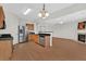 Open-concept kitchen with breakfast bar, fireplace, stainless appliances and modern lighting at 1795 Waterside Nw Dr, Kennesaw, GA 30152
