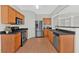 Well-equipped kitchen with wood cabinets, stainless steel appliances and black countertops at 1795 Waterside Nw Dr, Kennesaw, GA 30152