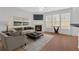 Bright living room with fireplace and large windows, perfect for relaxation and entertaining at 1795 Waterside Nw Dr, Kennesaw, GA 30152