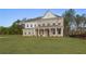 Charming brick home showcasing a covered front porch and expansive green lawn at 185 Haverling Pass, Hampton, GA 30228