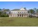 Elegant two-story brick home with a columned front porch and a spacious front yard at 185 Haverling Pass, Hampton, GA 30228