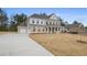 Beautiful brick home with a long driveway, attached garage, and well-manicured lawn at 185 Haverling Pass, Hampton, GA 30228
