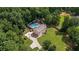 Aerial view of two story home with a large pool, long drive, and mature trees at 450 Ledbetter Rd, Villa Rica, GA 30180