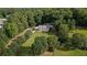 An aerial view of a two story home with a large pool, long drive, and mature trees at 450 Ledbetter Rd, Villa Rica, GA 30180