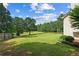 Spacious backyard with lush lawn, mature trees, and landscaping offers privacy and outdoor enjoyment at 450 Ledbetter Rd, Villa Rica, GA 30180