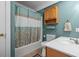Bathroom with a shower-tub combination, complemented by oak cabinets and sleek fixtures at 450 Ledbetter Rd, Villa Rica, GA 30180