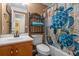 Bathroom with a turtle themed shower curtain, oak vanity and cabinet at 450 Ledbetter Rd, Villa Rica, GA 30180