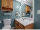 This bathroom features a wood cabinet vanity with a framed mirror and clean white sink at 450 Ledbetter Rd, Villa Rica, GA 30180