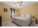 Comfortable bedroom with a ceiling fan, a patterned comforter and bedside table at 450 Ledbetter Rd, Villa Rica, GA 30180