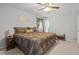Bright bedroom with a ceiling fan, decorative bed set, and calming wall decor at 450 Ledbetter Rd, Villa Rica, GA 30180