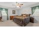 Cozy bedroom features a ceiling fan, a decorative bed set and matching nightstands at 450 Ledbetter Rd, Villa Rica, GA 30180