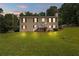 Charming two-story home featuring red shutters, an American flag, and a spacious green lawn at 450 Ledbetter Rd, Villa Rica, GA 30180