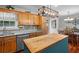 Kitchen with wood cabinets, stainless steel appliances, and an island with a butcher block top at 450 Ledbetter Rd, Villa Rica, GA 30180