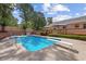 Backyard pool with diving board, deck and mature landscaping, perfect for summer fun and entertainment at 450 Ledbetter Rd, Villa Rica, GA 30180
