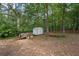 Large wooded lot with an outbuilding shed and an old utility trailer at 450 Ledbetter Rd, Villa Rica, GA 30180