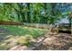 Spacious backyard with lush lawn, mature trees, a privacy fence and a wooden deck at 1788 Campbellton Sw Rd, Atlanta, GA 30311