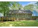 Backyard with deck, green grass, and mature trees at 1788 Campbellton Sw Rd, Atlanta, GA 30311