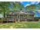 Exterior backyard with deck, lush lawn and tree coverage on a sunny day at 1788 Campbellton Sw Rd, Atlanta, GA 30311