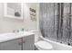 Bathroom featuring a gray vanity, combined tub and shower with gray patterned curtain at 1788 Campbellton Sw Rd, Atlanta, GA 30311