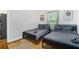Bright bedroom with two twin beds, hardwood floors, art, decor, laundry unit and a modern rug at 1788 Campbellton Sw Rd, Atlanta, GA 30311