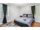 Bedroom with natural light, hardwood floors, a queen bed, black out curtains and neutral wall colors at 1788 Campbellton Sw Rd, Atlanta, GA 30311