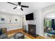 Cozy living room with a fireplace, hardwood floors, and an abundance of natural light at 1788 Campbellton Sw Rd, Atlanta, GA 30311