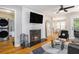 Well-lit living room featuring a fireplace, hardwood floors, and an open layout at 1788 Campbellton Sw Rd, Atlanta, GA 30311