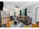 Cozy living room featuring a modern sofa, hardwood floors, and an abundance of natural light at 1788 Campbellton Sw Rd, Atlanta, GA 30311