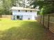 Spacious backyard featuring an attached patio, well-maintained lawn, and a private fence at 2099 Redbud Sw Ct, Marietta, GA 30008