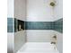 Soaking tub with tile surround, built-in niche, and bronze fixtures at 2099 Redbud Sw Ct, Marietta, GA 30008