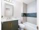 Updated bathroom features a modern vanity, patterned tile, and a tub with shower at 2099 Redbud Sw Ct, Marietta, GA 30008