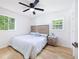 Bright bedroom with hardwood floors, a modern ceiling fan, and a comfortable queen-sized bed at 2099 Redbud Sw Ct, Marietta, GA 30008