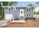 Split-level home has a grey brick facade, a white front door, and a one-car garage at 2099 Redbud Sw Ct, Marietta, GA 30008
