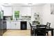 Updated kitchen has modern appliances, stone counters and backsplash, and white cabinets at 2099 Redbud Sw Ct, Marietta, GA 30008