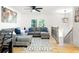 Open living area with hardwood floors, a gray sectional, and a stairway to another level at 2099 Redbud Sw Ct, Marietta, GA 30008