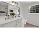 Bright bathroom featuring a double vanity, modern mirrors, and contemporary fixtures at 8689 Cedar Creek Rdg, Riverdale, GA 30274