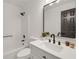 Bathroom featuring shower-tub combination, modern sink, and matte black fixtures at 8689 Cedar Creek Rdg, Riverdale, GA 30274