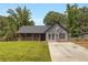 Charming one-story home featuring modern brickwork, a cozy front porch, and a well-manicured lawn at 8689 Cedar Creek Rdg, Riverdale, GA 30274
