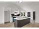 Bright kitchen features modern island, white cabinets, stainless steel appliances, and an eye-catching backsplash at 8689 Cedar Creek Rdg, Riverdale, GA 30274