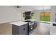 Modern kitchen featuring a large island with stove and oven, new appliances, and sliding doors to the backyard at 8689 Cedar Creek Rdg, Riverdale, GA 30274