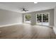 Bright and open living room with hardwood floors, two large windows, and a ceiling fan at 8689 Cedar Creek Rdg, Riverdale, GA 30274