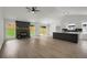 Open-concept living area showcases a cozy fireplace, modern lighting, and a stylish kitchen island at 8689 Cedar Creek Rdg, Riverdale, GA 30274