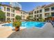 Community pool surrounded by lounge chairs and greenery at 955 Juniper Ne St # 4127, Atlanta, GA 30309